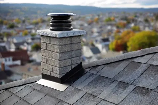 Stone chimney with new cap and flashing in Southern Village